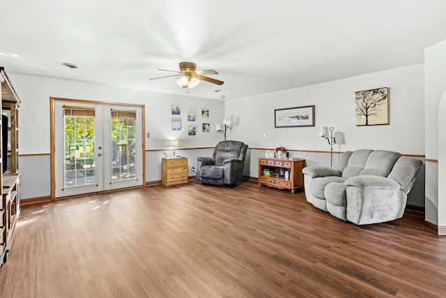 living room featuring wood-type flooring, ceiling fan, and french doors