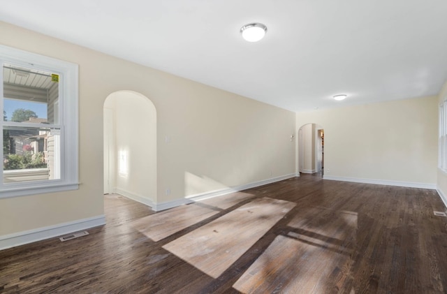 empty room with dark hardwood / wood-style floors