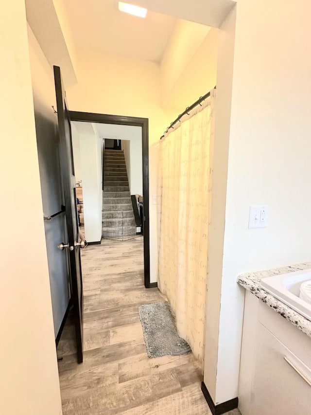 hall with stairway and light wood-style flooring