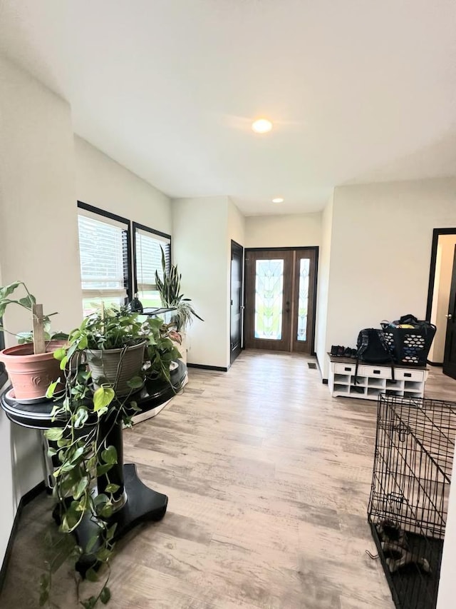 entryway featuring recessed lighting, light wood-style flooring, and baseboards