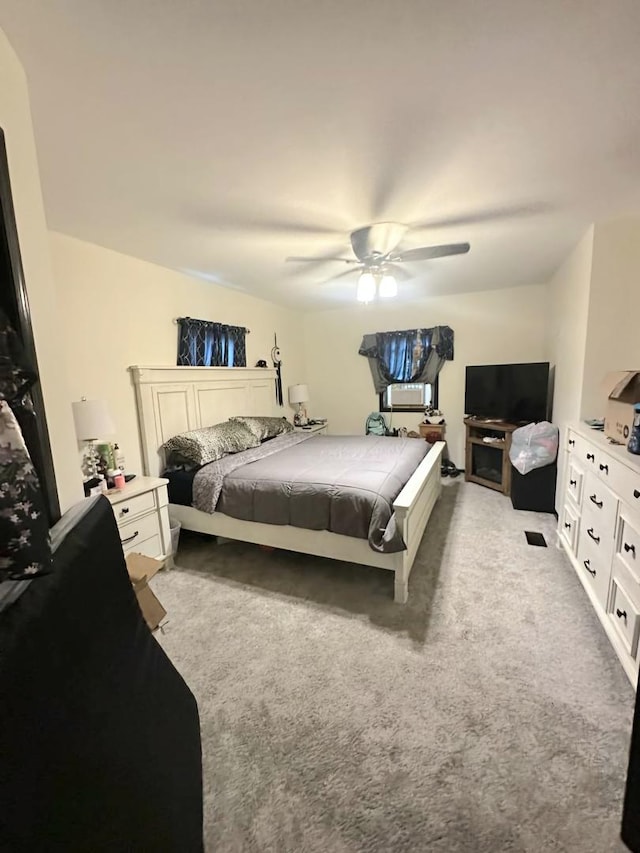 bedroom with a ceiling fan and light carpet