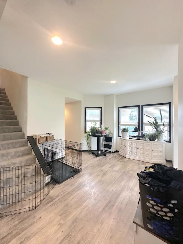 living room featuring recessed lighting, stairway, and wood finished floors