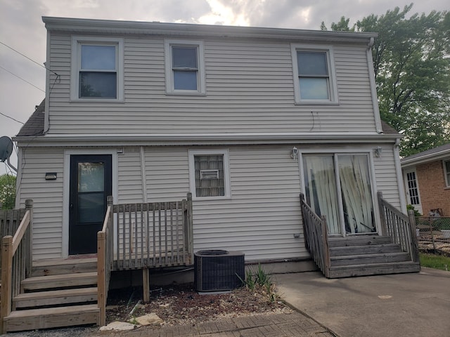 rear view of house featuring central air condition unit