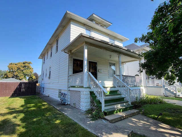 view of front of property with covered porch and a front lawn