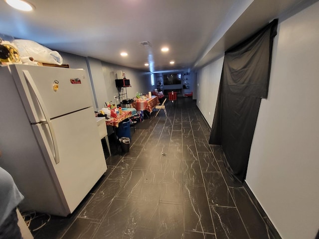 kitchen featuring marble finish floor, recessed lighting, and freestanding refrigerator