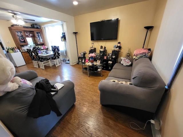 living room featuring a ceiling fan and hardwood / wood-style flooring