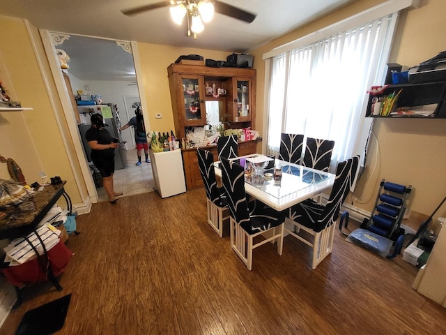 dining area featuring dark hardwood / wood-style floors and ceiling fan