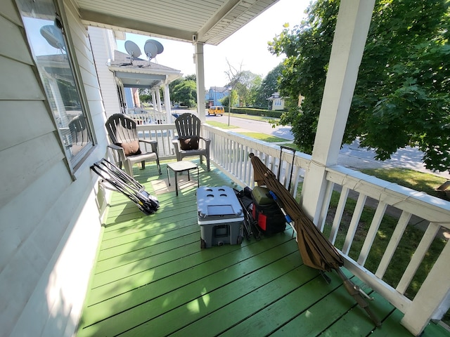 wooden terrace featuring covered porch