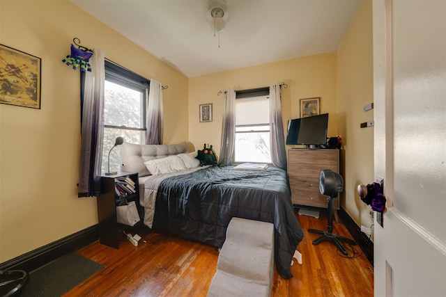 bedroom with ceiling fan and hardwood / wood-style flooring