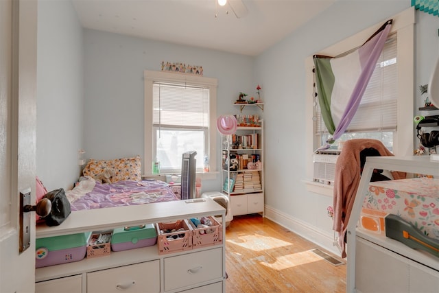 bedroom with ceiling fan and light hardwood / wood-style floors