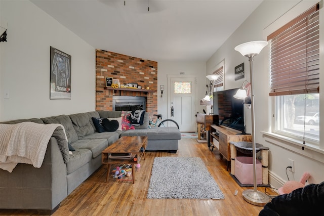 living room with a fireplace and light hardwood / wood-style floors