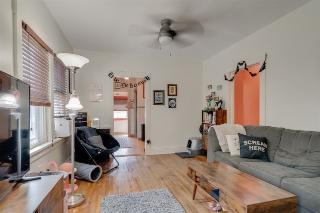 living room with a healthy amount of sunlight, light hardwood / wood-style flooring, and ceiling fan