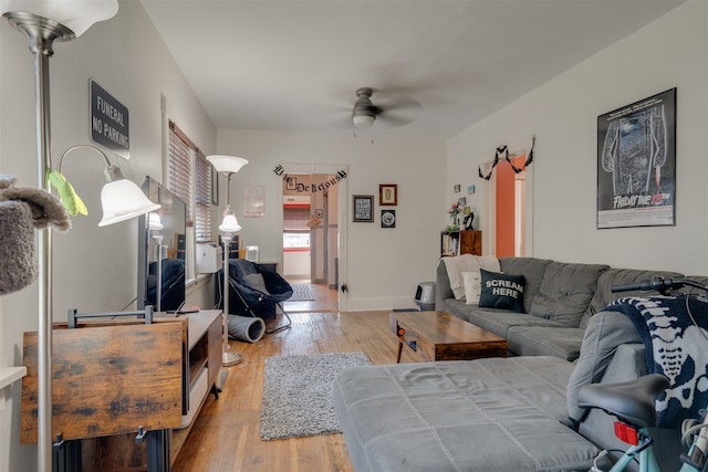 living room with ceiling fan and light hardwood / wood-style floors