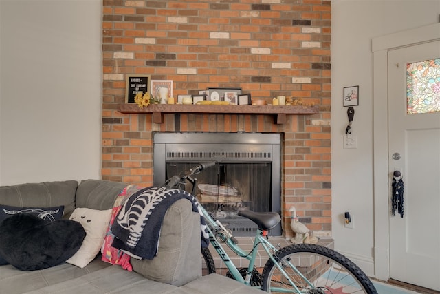 living room featuring a brick fireplace