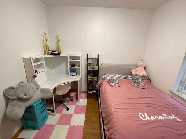 bedroom with hardwood / wood-style floors