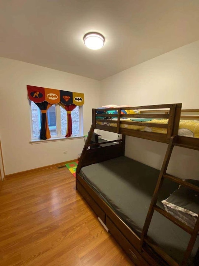 bedroom with hardwood / wood-style floors