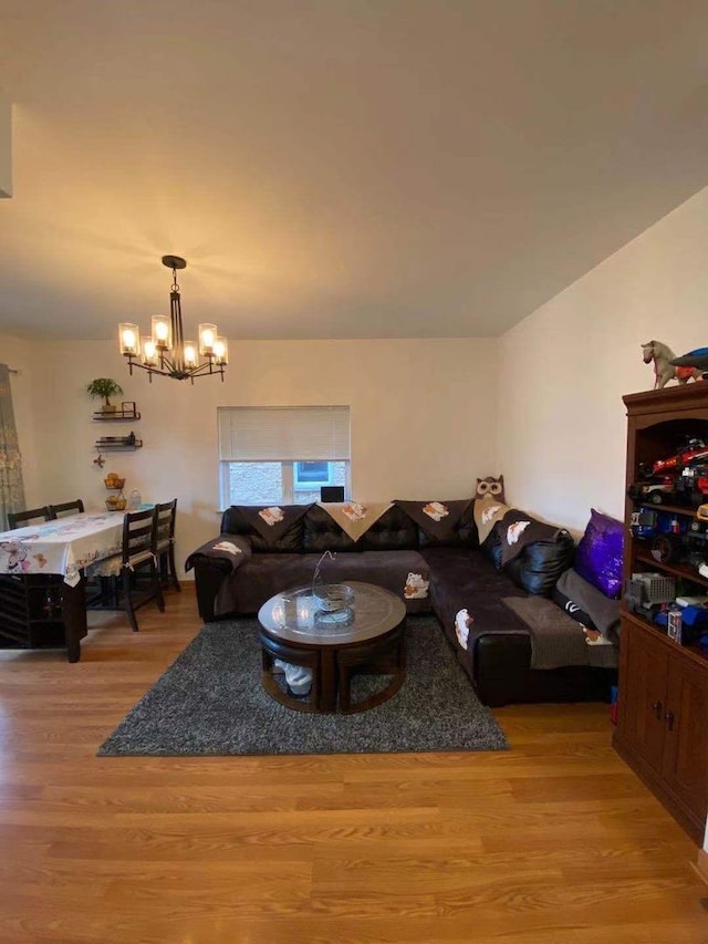 living room with wood-type flooring and an inviting chandelier