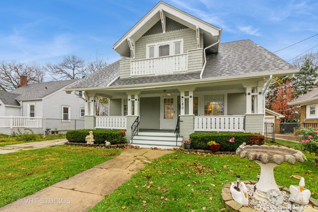 view of front of property with a front yard and a porch