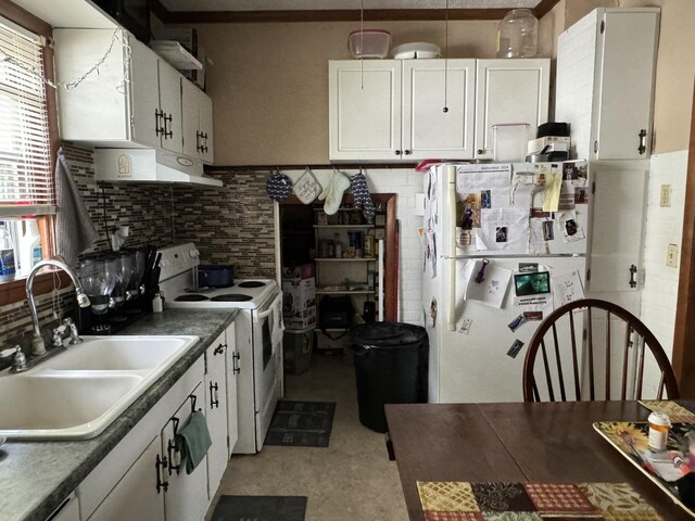 kitchen featuring sink, white appliances, white cabinetry, and tasteful backsplash