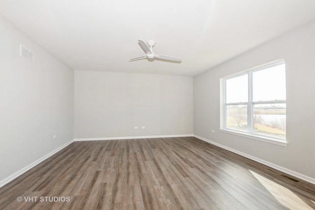 spare room with hardwood / wood-style flooring and ceiling fan