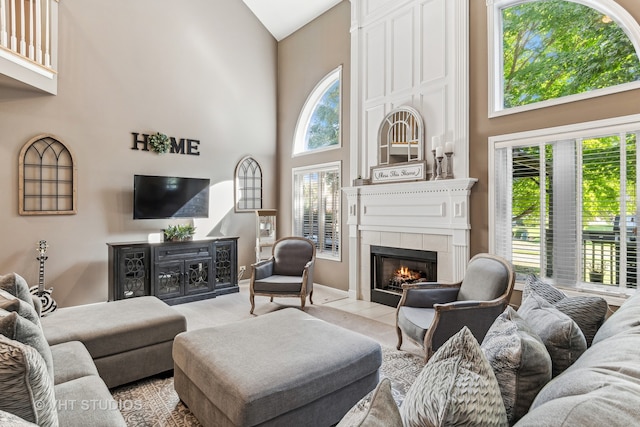 living room featuring a high ceiling and a tile fireplace