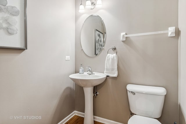 bathroom featuring toilet and hardwood / wood-style flooring