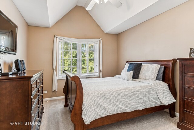 carpeted bedroom with vaulted ceiling and ceiling fan