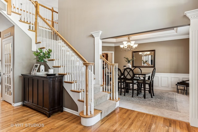 interior space featuring wood-type flooring, crown molding, and a notable chandelier