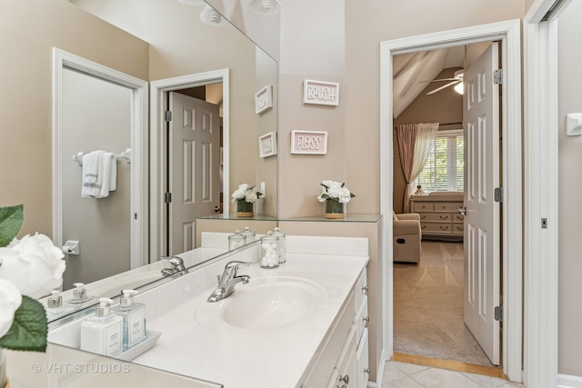 bathroom featuring vanity, vaulted ceiling, ceiling fan, and tile patterned floors