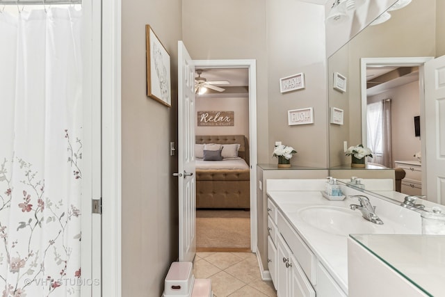 bathroom with tile patterned flooring, vanity, and ceiling fan