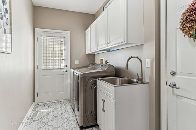 clothes washing area with cabinets, sink, independent washer and dryer, and light tile patterned flooring