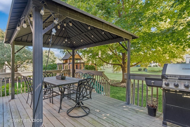 wooden terrace with a yard and a gazebo