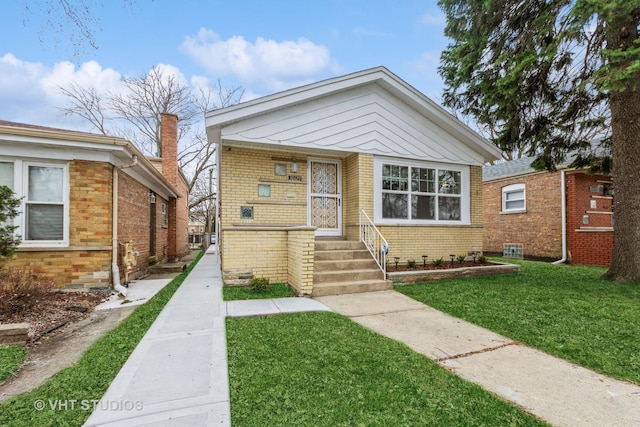 bungalow-style house with a front lawn