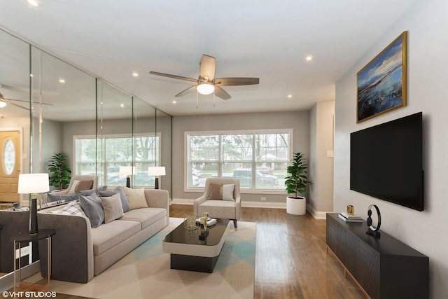 living room with hardwood / wood-style floors and ceiling fan