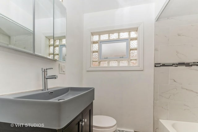 full bathroom featuring vanity, toilet, and tiled shower / bath