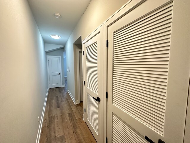 hallway with dark wood-type flooring