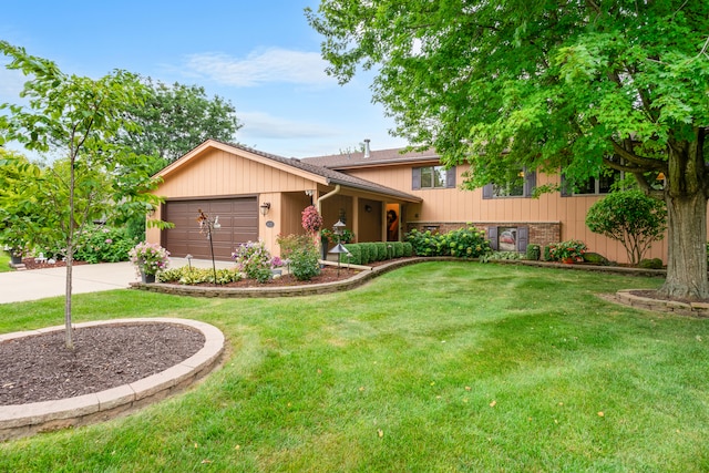 tri-level home with a garage and a front lawn