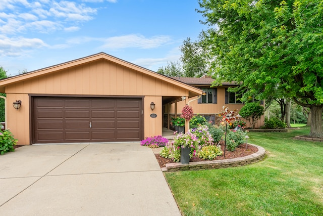 ranch-style home featuring a front lawn and a garage