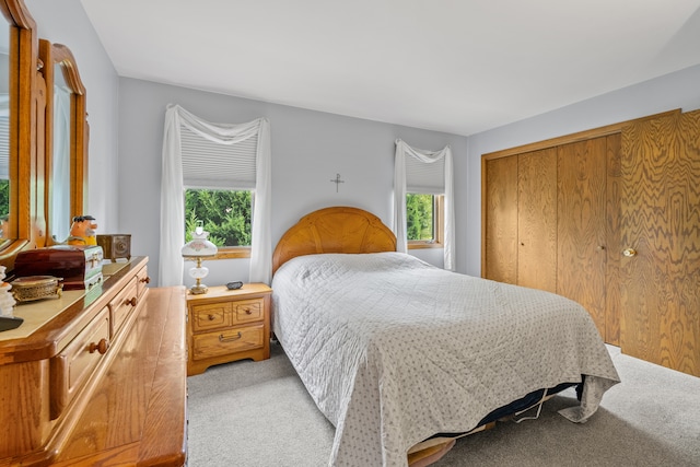 carpeted bedroom with a closet