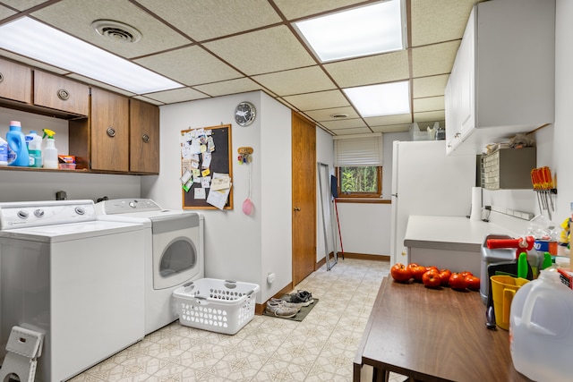 washroom featuring cabinets and separate washer and dryer