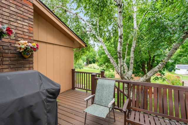 wooden deck featuring a grill