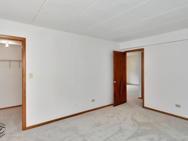 unfurnished room featuring light carpet