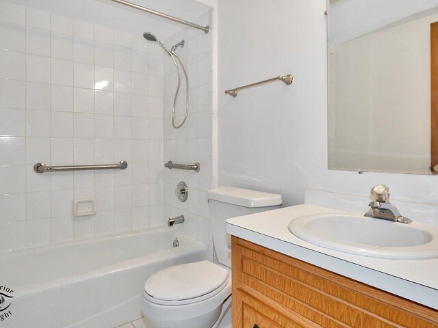 full bathroom with vanity, toilet, and tiled shower / bath combo