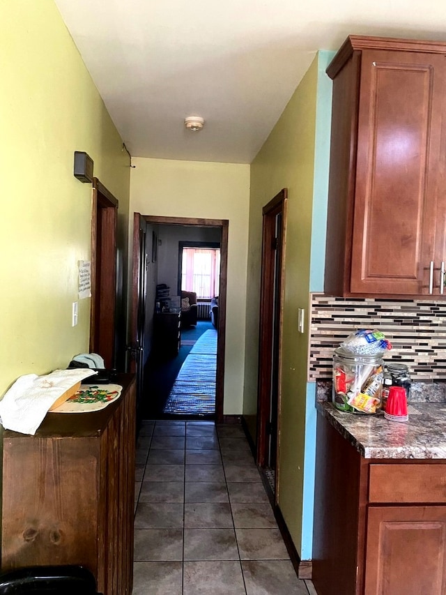 corridor featuring dark tile patterned floors