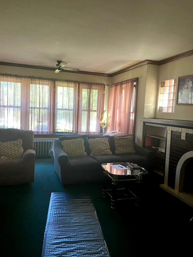 living room with a wealth of natural light, carpet, crown molding, and radiator heating unit