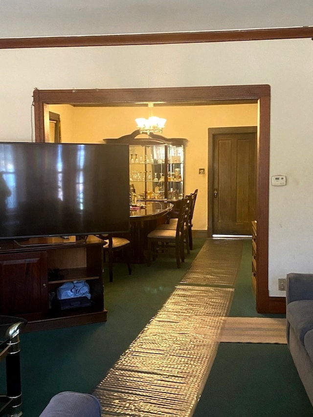 carpeted living room with a chandelier