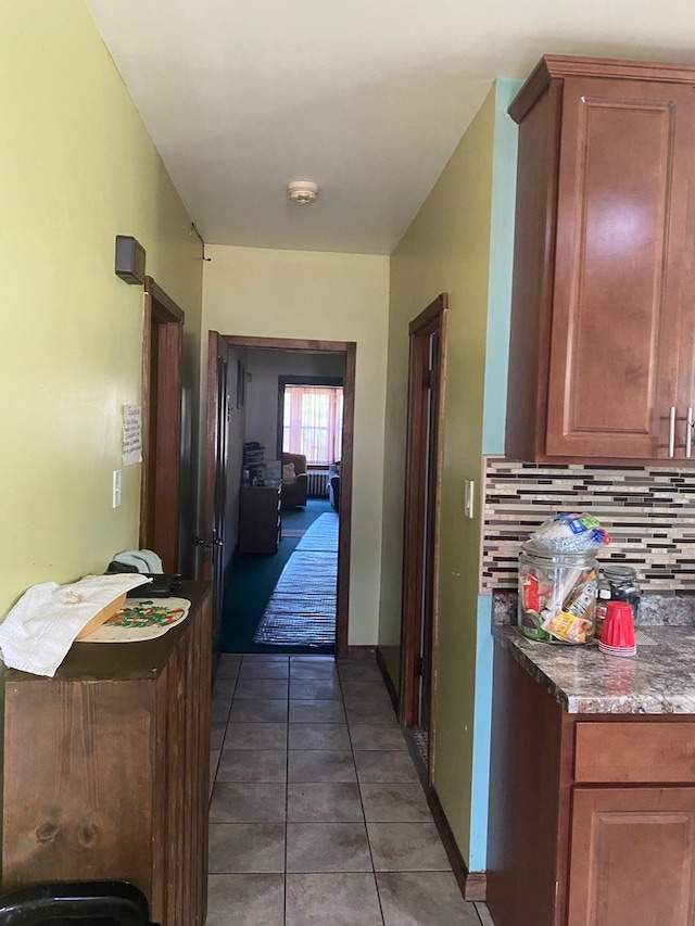 hallway with dark tile patterned flooring