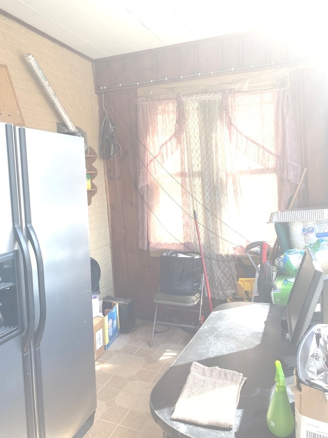 interior space featuring stainless steel fridge with ice dispenser