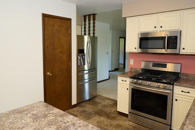 kitchen featuring baseboards, white cabinetry, and stainless steel appliances