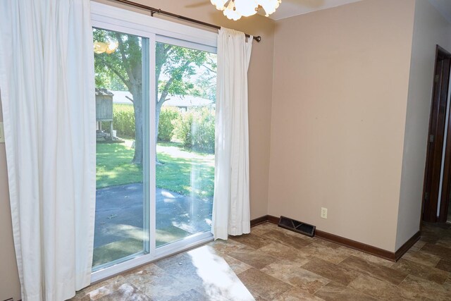 interior space featuring stone finish flooring, visible vents, and baseboards